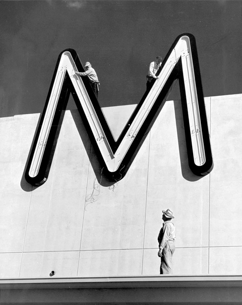 One of the four giant Ms on the top of the May Company building being installed