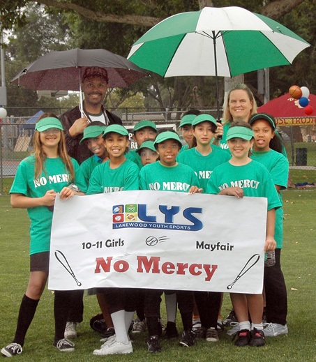 Girls hold their softball team banner