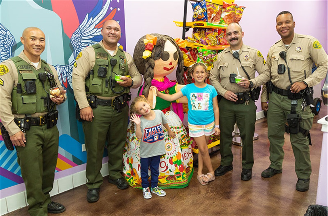 Deputy sheriffs and kids enjoy ice cream