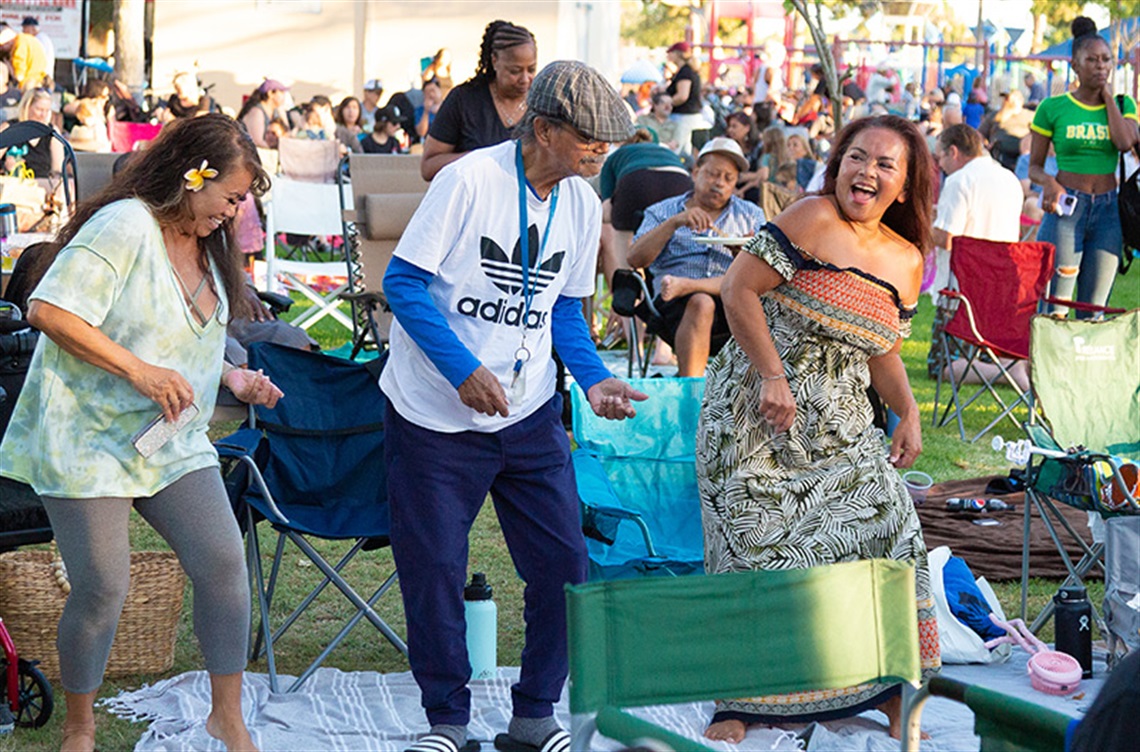 Three people dancing at Concerts in the Park