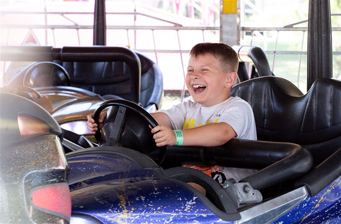 Laughing boy on bumper car