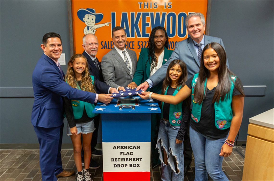 Girl Scouts with Lakewood City Council and flag collection box