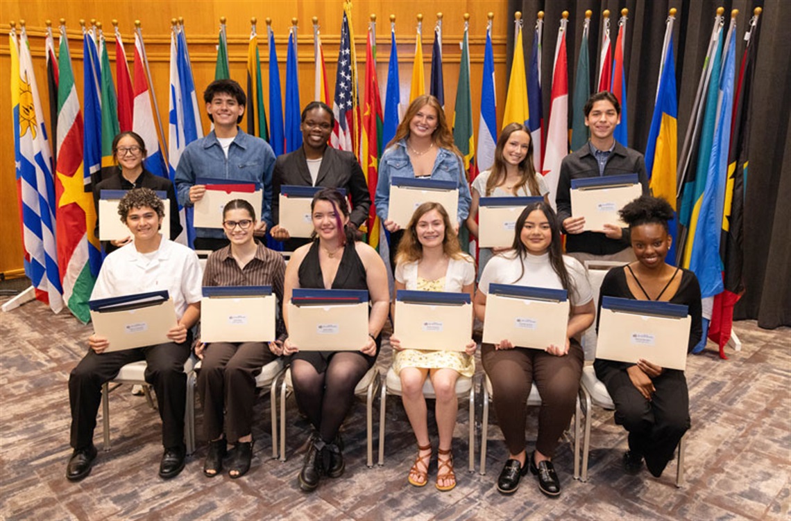 Twelve of the fifteen Pan Am Ambassadors pose with their certificates