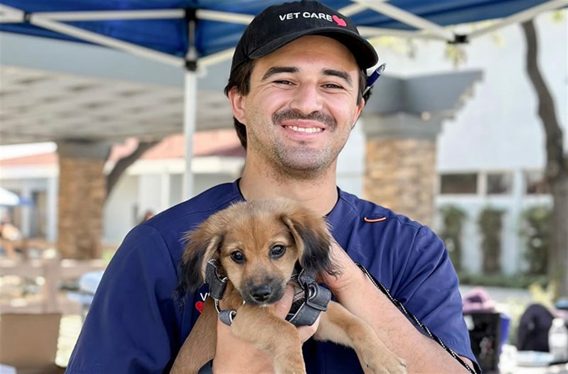 PetCare vet tech with puppy