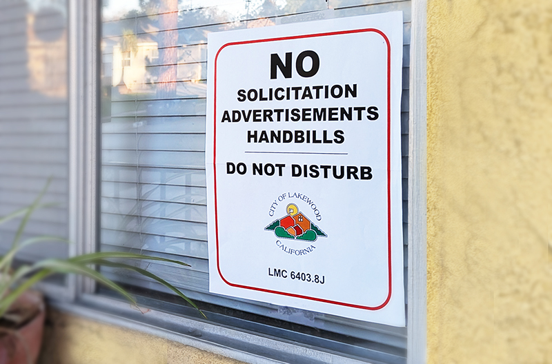 No Soliciting sign posted in window near front door