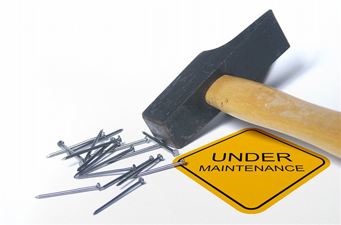 Hammer and nails and sign that says under maintenance