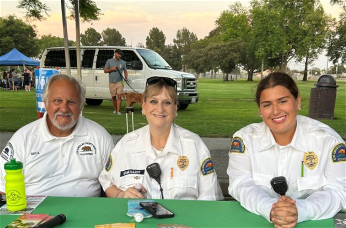 Some Volunteers on Patrol seated at table in park
